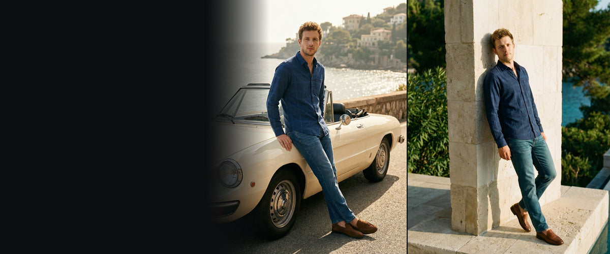 Derby blue jeans, beside a white convertible and against a stone pillar by the sea